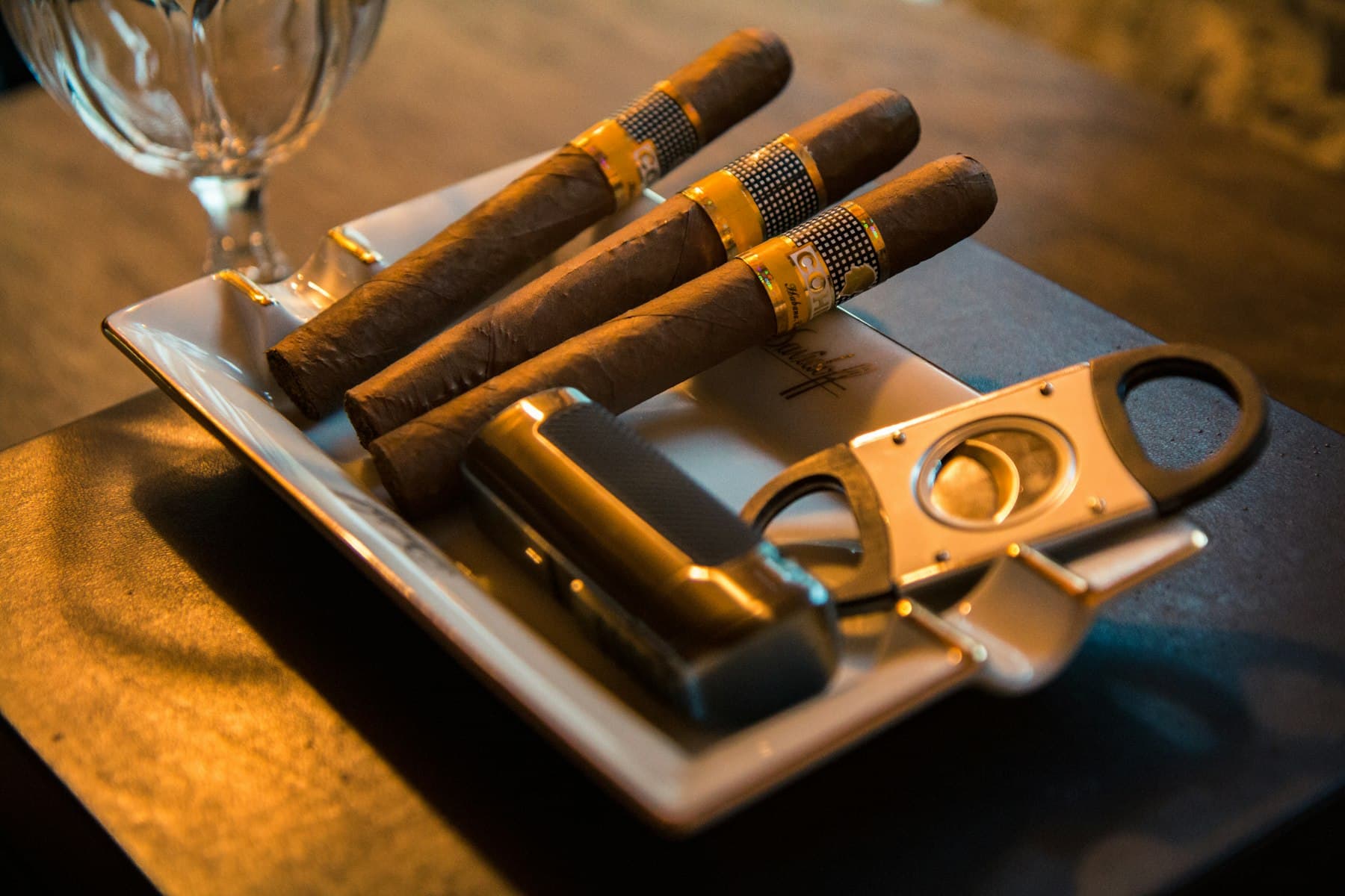 Cigars resting with a cutter and lighter